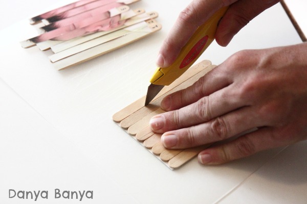 Use a sharp knife to cut the photo puzzle between each craft stick