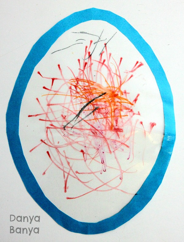 Preschooler Easter egg window art drawing with textas on sticky contact paper