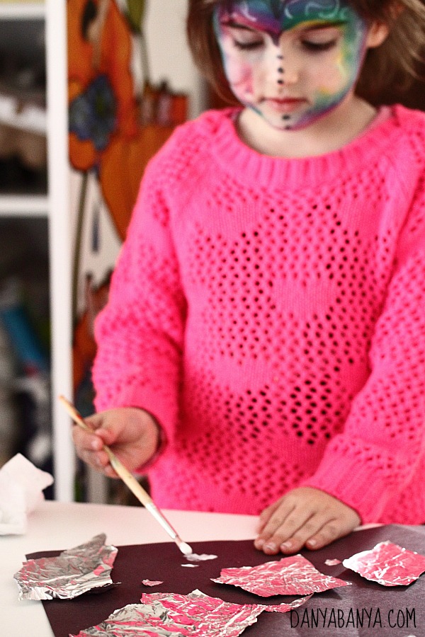 Ripping and gluing aluminium foil to make a fine motor starry night sky