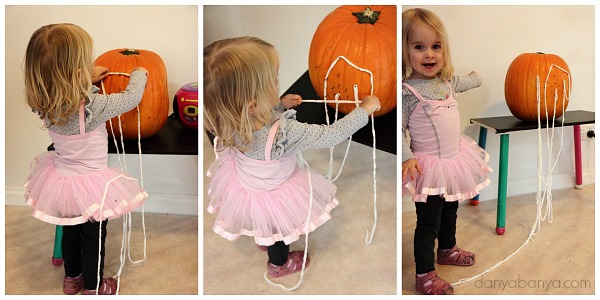 Toddler yarn play with the pumpkin geoboard