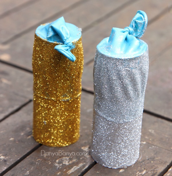 Add craft glue and super fine glitter to make the glitteriest DIY paper poppers ever