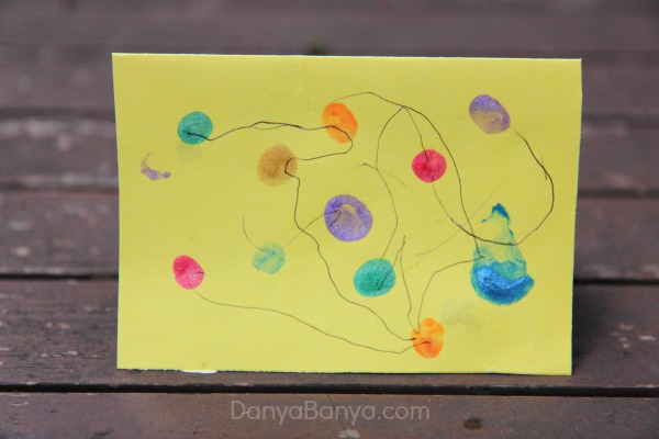 Fingerprint Christmas lights card painted and drawn by a preschooler