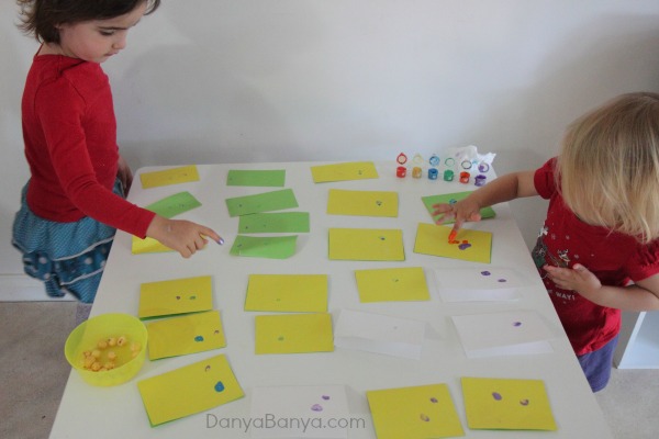 Painting multi-coloured fingerprints that will eventually become little christmas lights