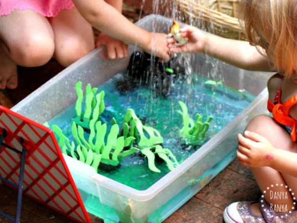 Playing with the ocean themed sensory bin