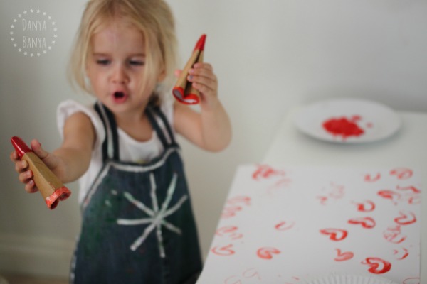 Wielding two heart stampers - great way for toddlers to use both sides of the brain at once