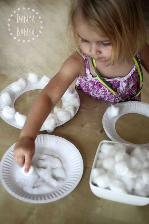 Pasting cotton wool to make paper plate sheep masks