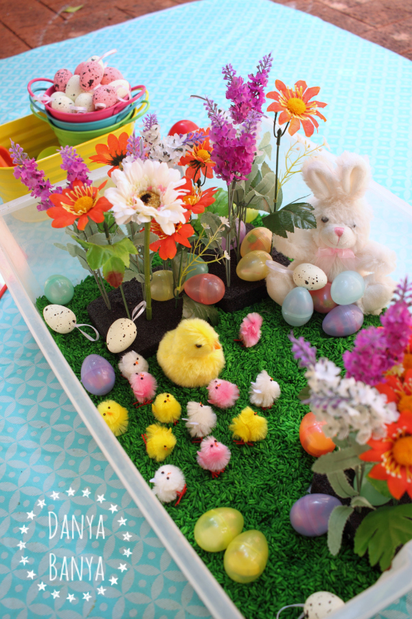 Easter themed sensory tub with chicks, eggs and flowers