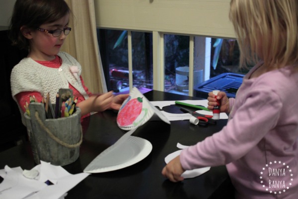 Kindergartener and toddler making tipping tea pots