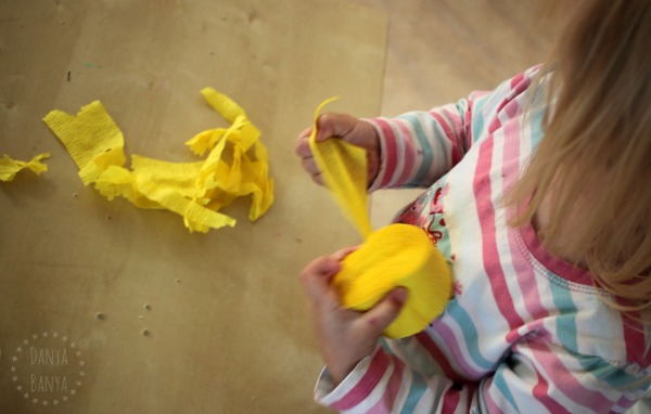 Toddler tearing streamers