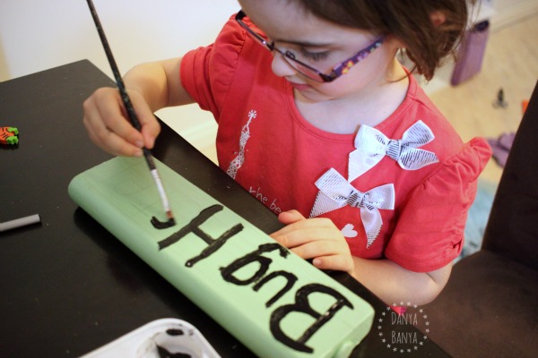 Painting a sign for the Bug Hotel