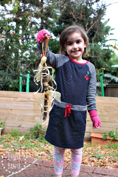 Kid-made gold ribbon stick ornament