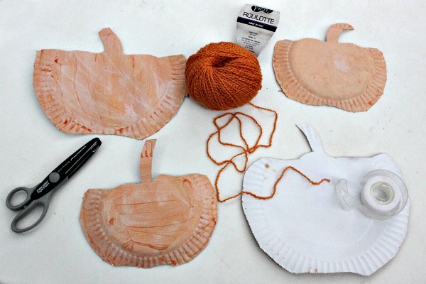 Sticky tape the yarn to the underside of the pumpkin