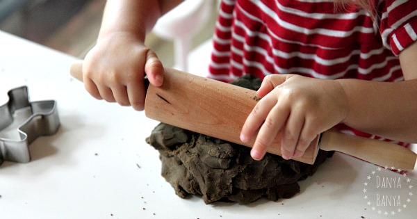 Toddler sensory play with gingerbread play dough and cookie cutters