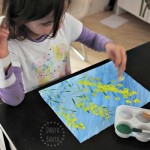 Painting wattle with pom poms