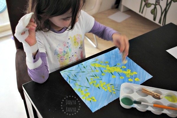 Painting wattle with pom poms