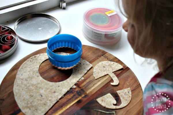 Cutting a multigrain wrap umbrella with a circular cookie cutter