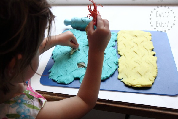 Creating waves in the sea and sand play dough