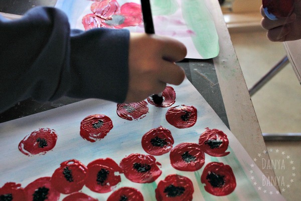 painting-the-black-centre-of-the-poppy-an-anzac-day-painting-to-remember-those-fallen